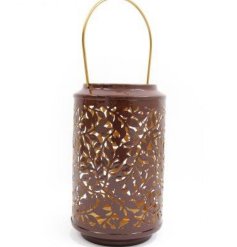 A stylish lantern with an intricate cut leaf design in earthy brown and gold colours.