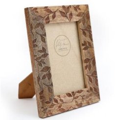 A chunky, natural wooden photo frame with a carved leaf design. 