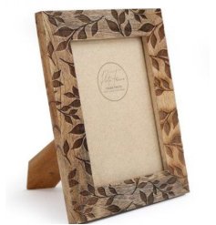 A chunky photo frame with a carved leaf design. A natural product with varying wood grains adding to the character 