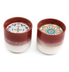 An assortment of 2 beautifully glazed ceramic candle pots with a colourful tile design holding card.