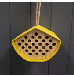 a bright and colourful bee house hung from chunky twine