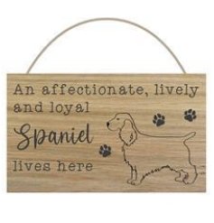 A hanging wooden sign with "an affectionate, lively and loyal Spaniel lives here" text and illustration with paw prints.