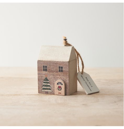 A sparkling miniature wooden house with 3D details and painted seasonal decorations. 