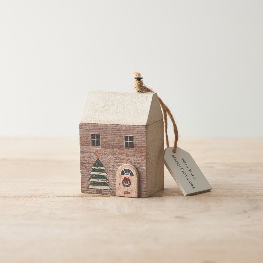 A charming seasonal decoration and gift item with magical details including a silver glitter roof and 3D door