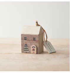 A charming wooden house ornament with a silver glitter roof, 3D door and festive painted details. 