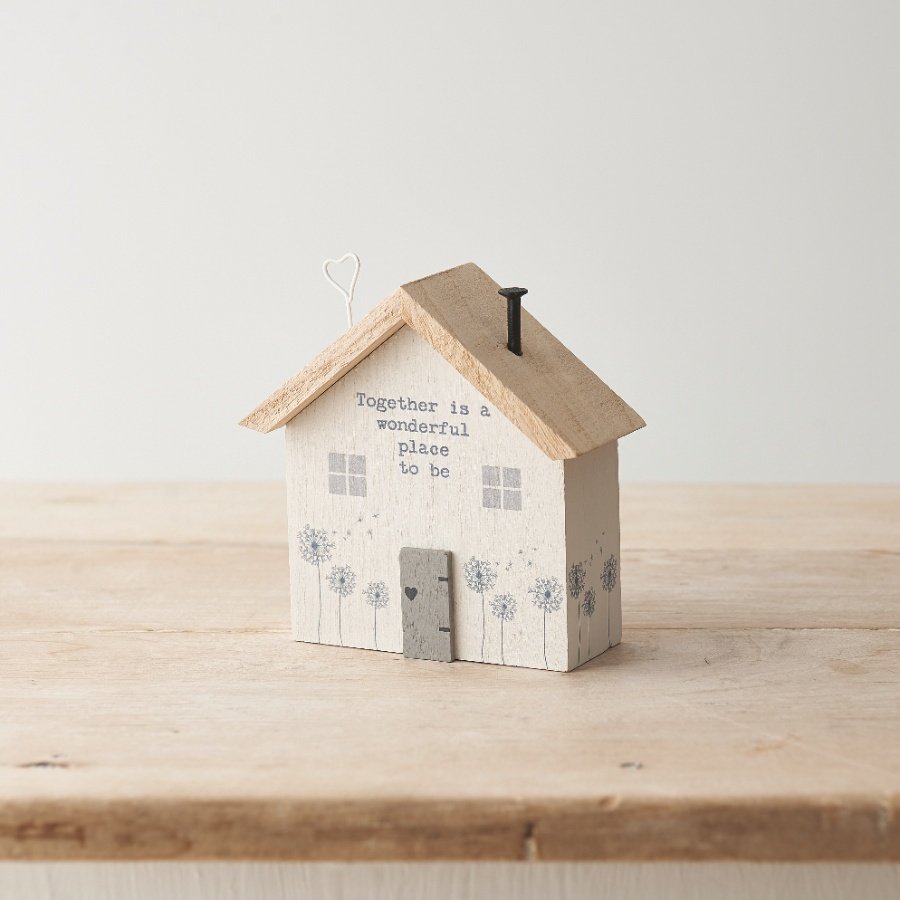 A charming wooden house with a painted slogan and hand finished details. 