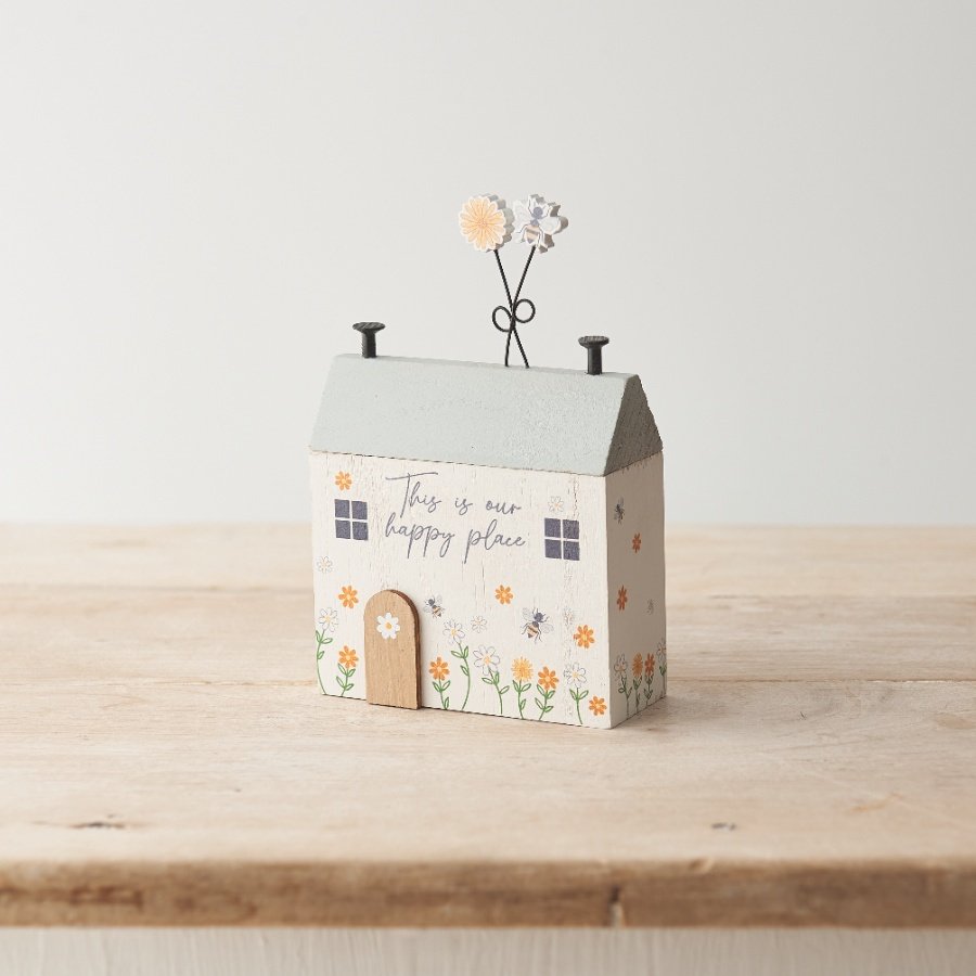 A sweet wooden house decoration with "this is our happy place" message and pretty bee/ floral details. 