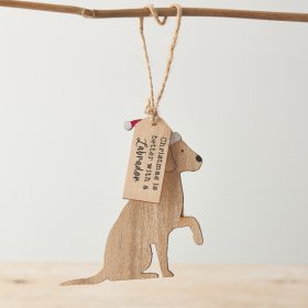 An adorable wooden Labrador decoration with a painted Christmas hat and jute string hanger. 