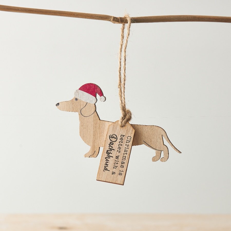 A hanging decoration with dachshund silhouette, Santa hat and "Christmas is better with a dachshund" tag. 