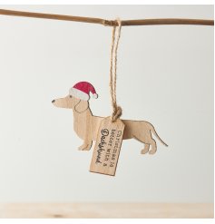 A dachshund shaped hanging decoration with Santa hat and "Christmas is better with a dachshund" tag. 