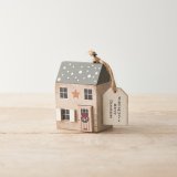 A charming wooden house ornament with traditional painted details and 3D wooden elements. 