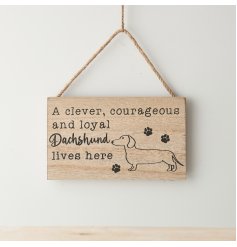 "A clever, courageous and loyal dachshund lives here" hanging wooden sign with paw print details.