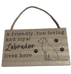 A hanging wooden sign with "a friendly, fun-loving & loyal Labrador lives here" text & illustration with paw prints.