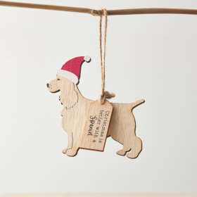 A wooden hanging decoration with a Spaniel silhouette, red Santa hat and "Christmas is better with a Spaniel" text. 
