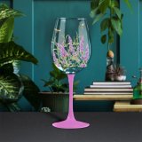 floral wine glass in a lavender design with a brightly coloured stem