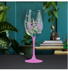 floral wine glass in a lavender design with a brightly coloured stem
