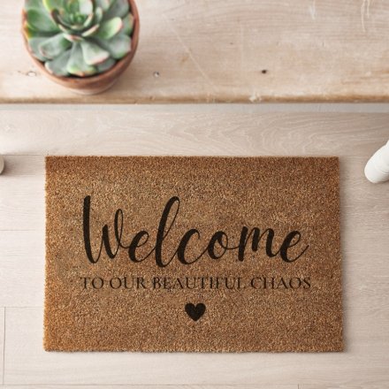 A simple yet stylish coir doormat with heart detail and "welcome to our beautiful chaos" message. 