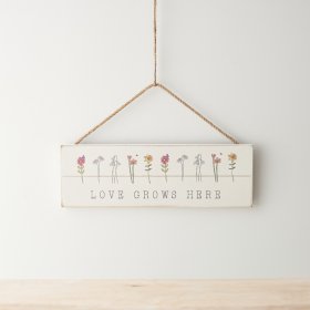 A sweet wooden sign hung by jute rope featuring dainty floral images.