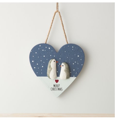 blue and white snow scene heart sign showing two penguins facing each other