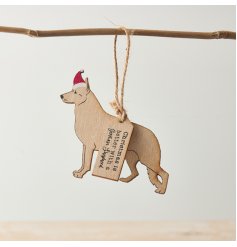 A wooden silhouette hanger of a German Shepherd wearing a Christmas hat.