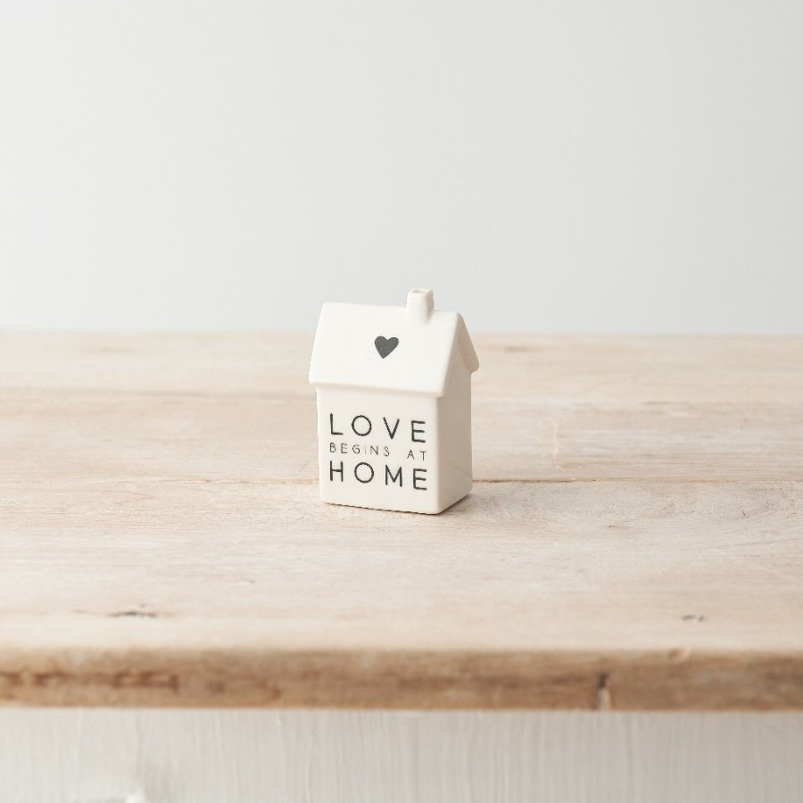 A simple yet stylish porcelain house decoration with "love begins at home" message and heart motif. 