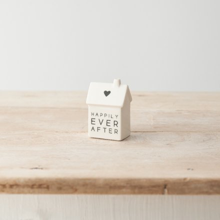 A cute porcelain house decoration with simple heart motif and "happily ever after" message. 
