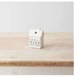 A cute porcelain house decoration with simple heart motif and "happily ever after" message. 