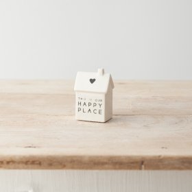 A stylish porcelain house decoration with simple heart motif and "this is our happy place" text. 