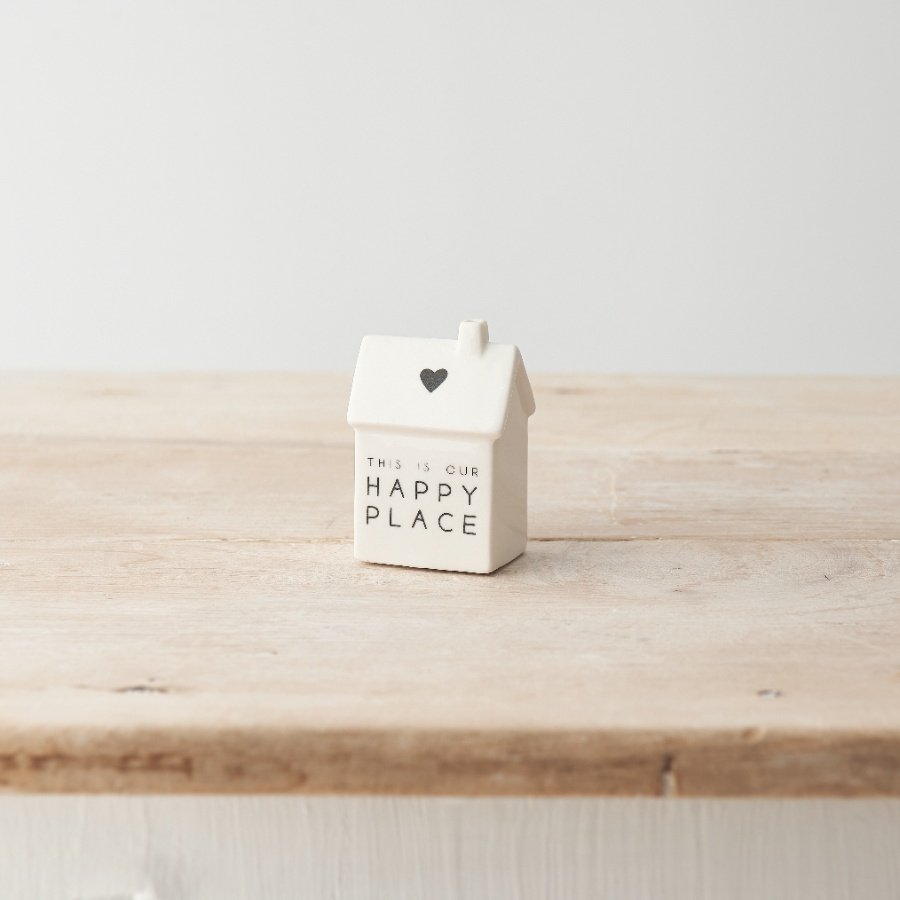 A stylish porcelain house decoration with simple heart motif and "this is our happy place" text. 