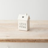 A charming porcelain house decoration with a monochrome colour scheme, "love begins at home" text and cute heart detail.