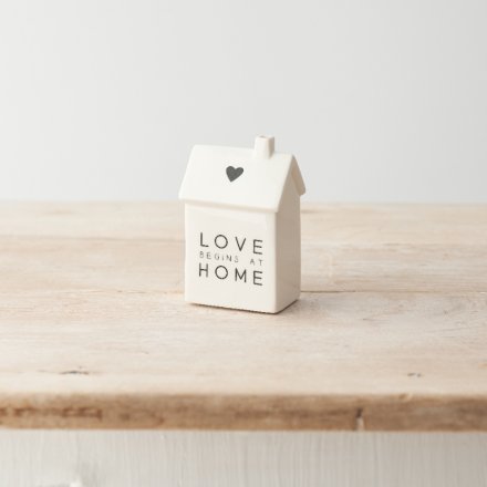A charming porcelain house decoration with a monochrome colour scheme, "love begins at home" text and cute heart detail.