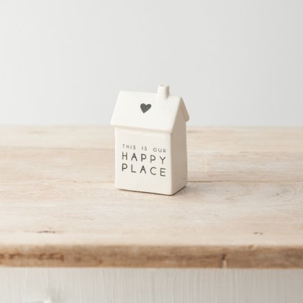 A simple yet stylish porcelain house decoration with "this is our happy place" message and cute heart motif. 