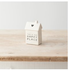 A stylish porcelain house decoration with "this is our happy place" message with heart detail. 