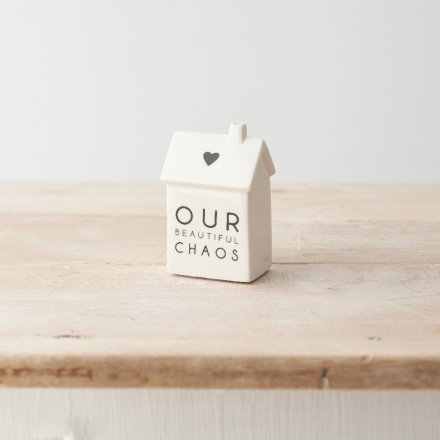 A simple yet stylish porcelain house decoration with "our beautiful chaos" message and heart detail. 