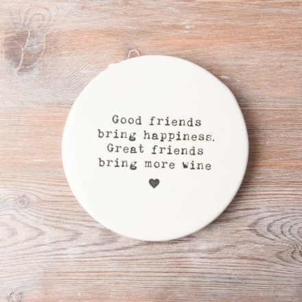 A stylish coaster with a printed friendship and wine slogan. A unique gift item and interior accessory for the home. 