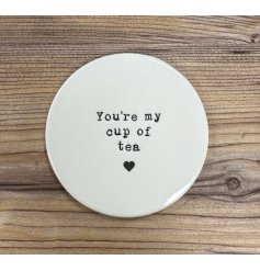 Keep surfaces safe whilst enjoying a cuppa with this charming porcelain coaster, complete with an embossed tea slogan. 