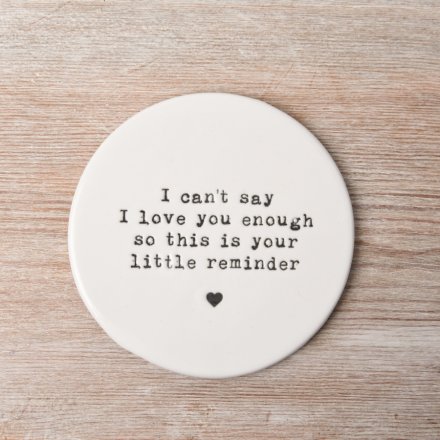 This round porcelain coaster is decorated with an embossed stamp style slogan.