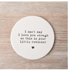 This round porcelain coaster is decorated with an embossed stamp style slogan.