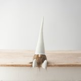 A cute simple sitting gonk wearing a corduroy white hat and matching boots.