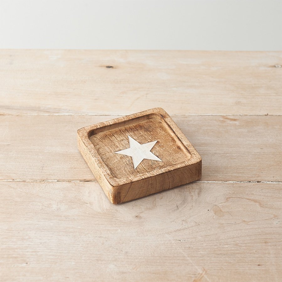 A stylish chunky wooden decorative plate with etched star motif in a contrasting whitewashed finish. 