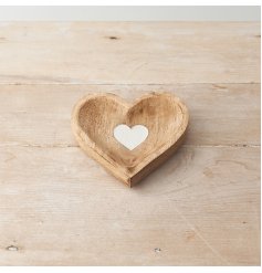 A beautifully crafted wooden heart shaped dish with visible woodgrain and a sweet white washed heart to the centre.