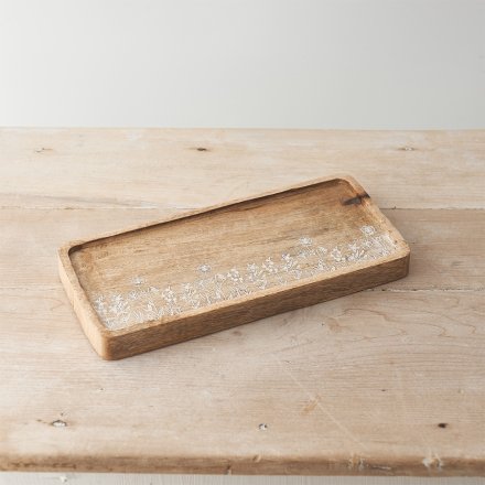 A rustic wooden tray with a stunning wild flower etched design with a white washed finish. 