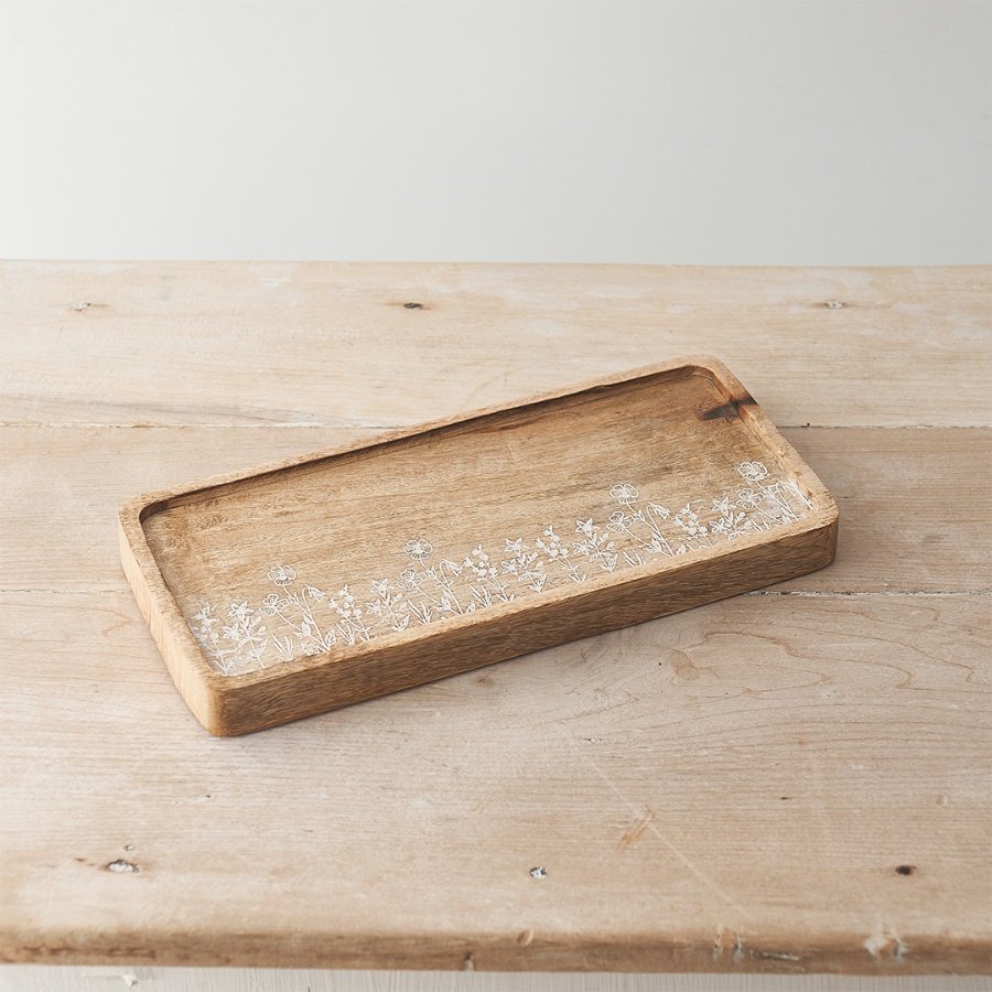 A rustic mango wood tray with a beautiful wild flower etched design. 