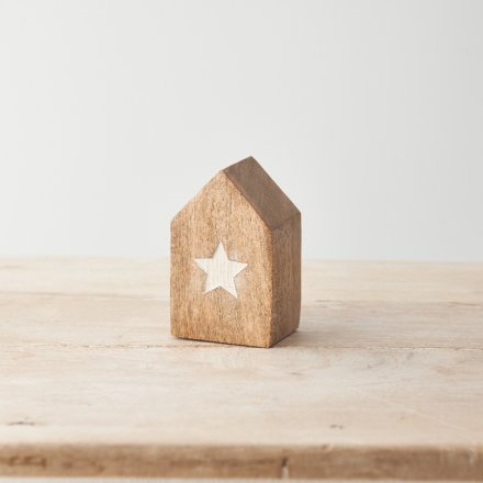 A rustic wooden house with an embossed white star