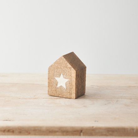 A little wooden house with a white embossed star