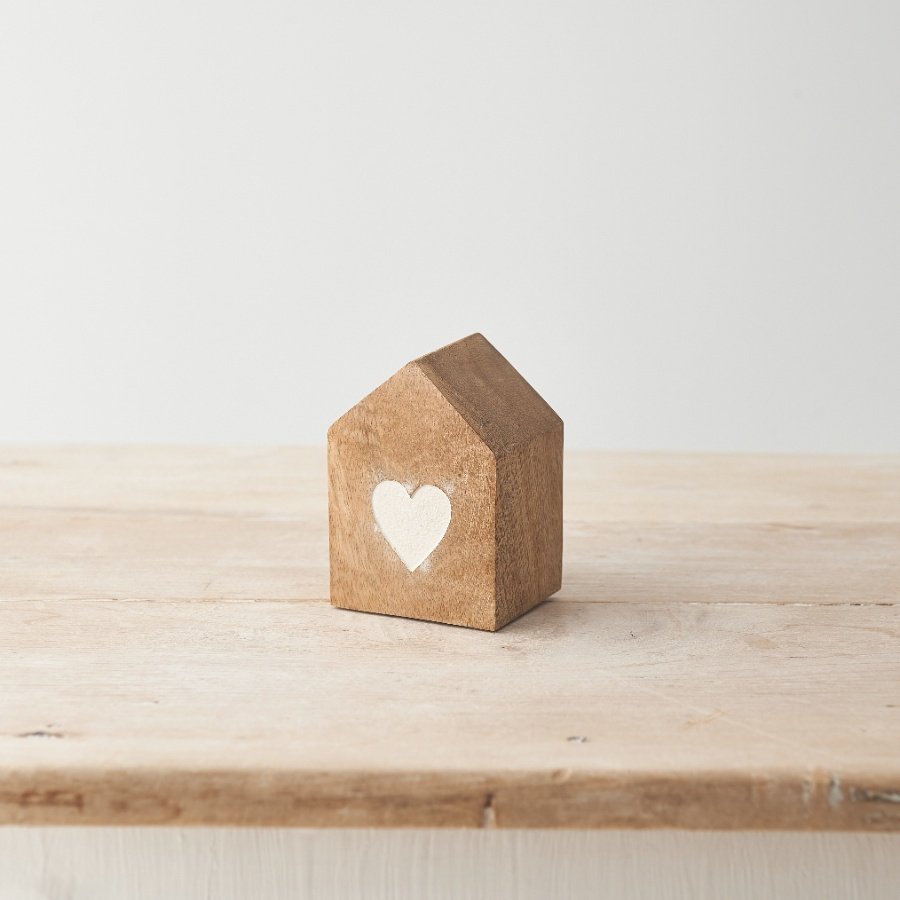 A charming natural wooden house decoration with a chic etched heart detail. 