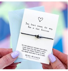 A mini wish bracelet with silver star charm, presented on a card with motivational message. 