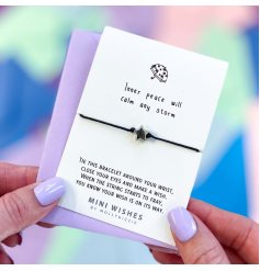 A mini wish bracelet with silver star charm, presented on a card with "inner peace will calm any storm" text. 