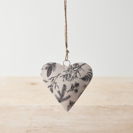 A seasonal hanging heart decoration with a rustic Christmas foliage print in monochrome colours. 