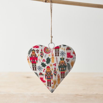 A metal heart decoration with jute string hanger. A colourful seasonal decoration with a traditional nutcracker design.
